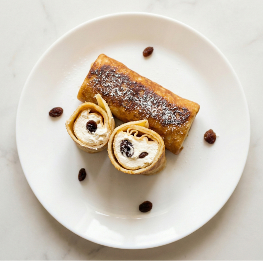 Thin crepes filled with sweet cottage cheese and raisins